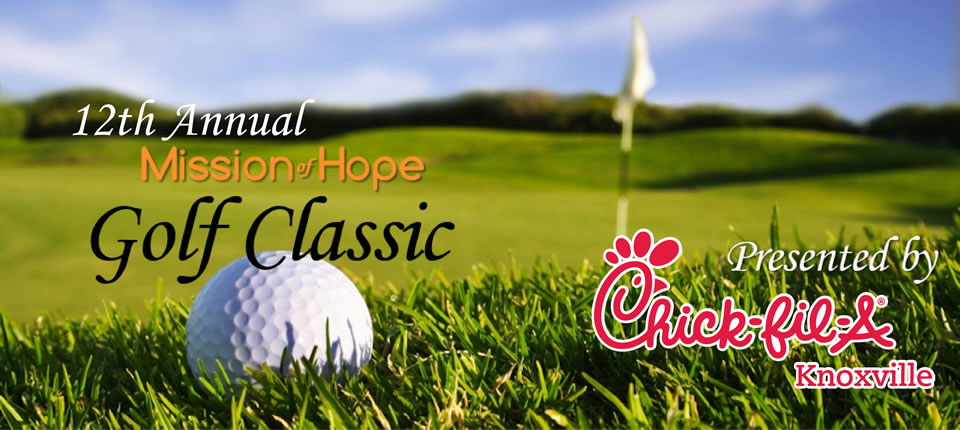 A golf ball on the grass with the words mission hope golf classic.