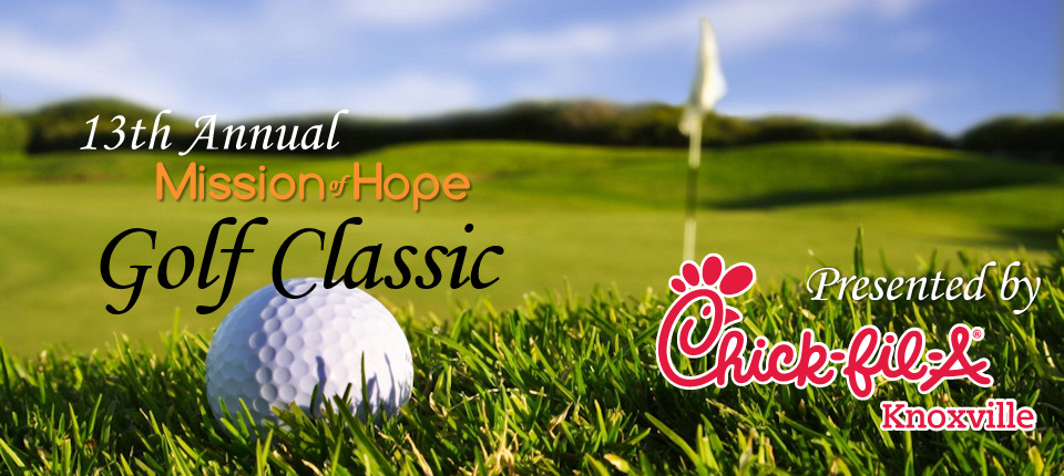 A golf ball in the grass with the words mission hope golf classic.