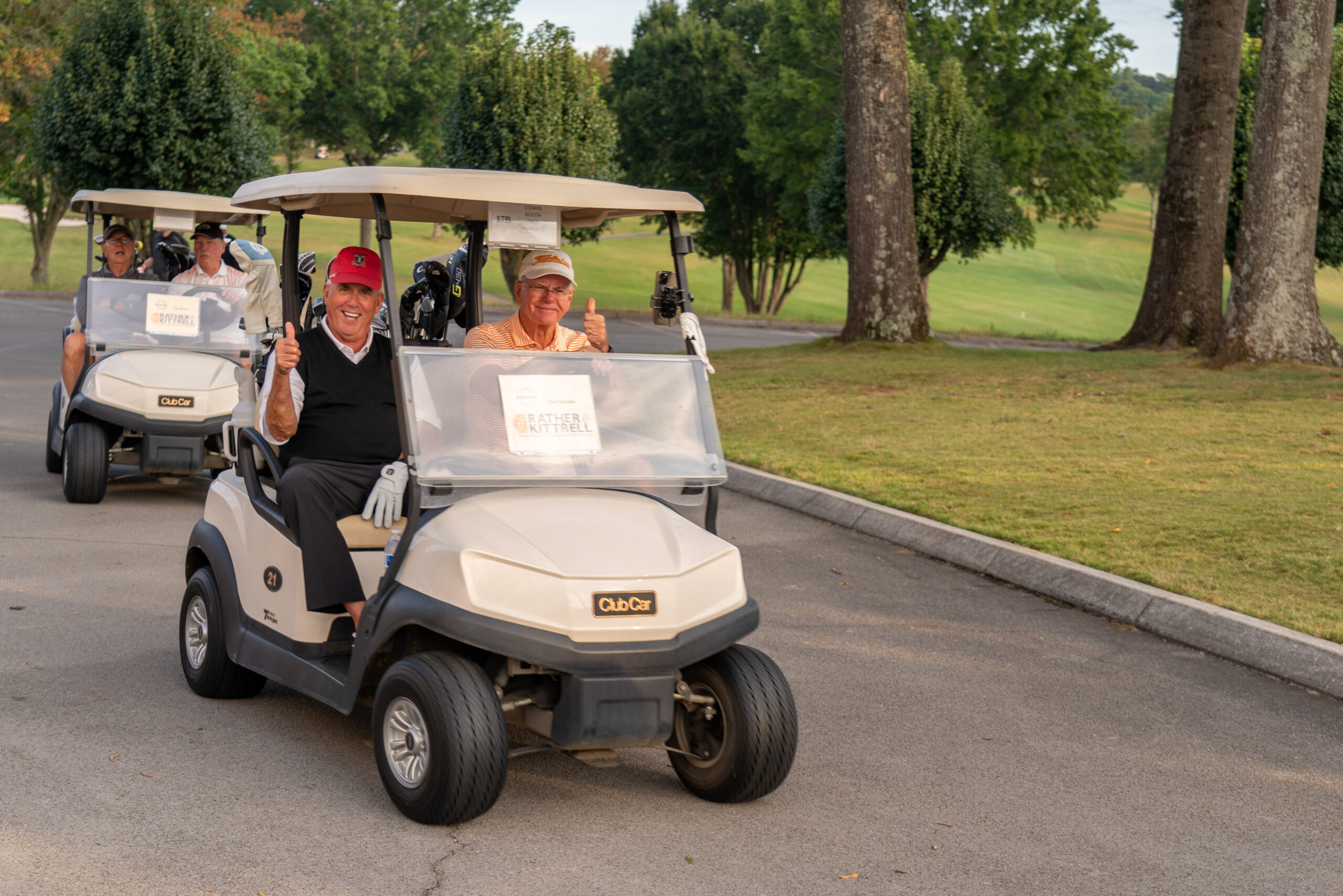 A group of people on a golf cart.